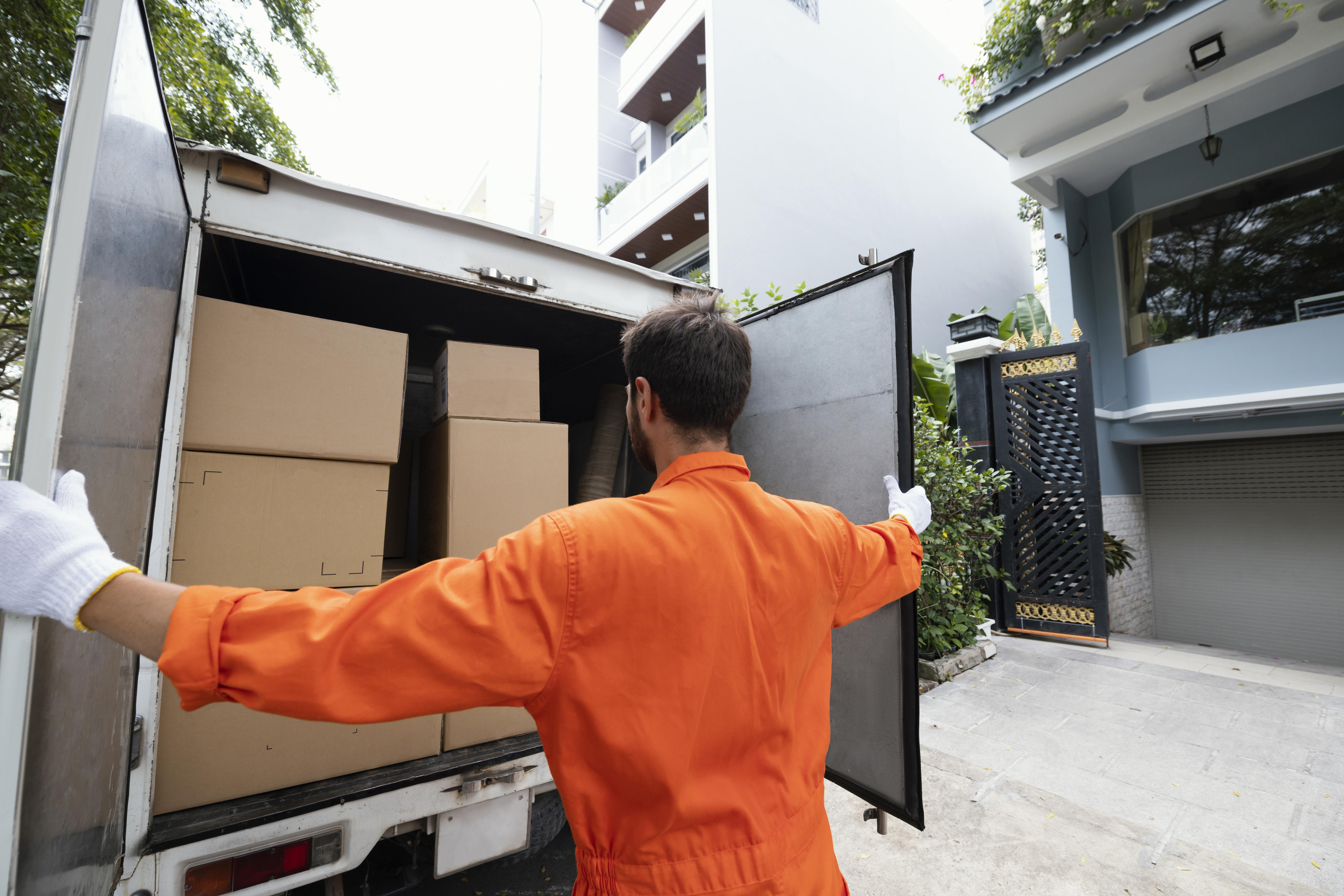 young-delivery-man-closing-delivery-truck-doors.jpg